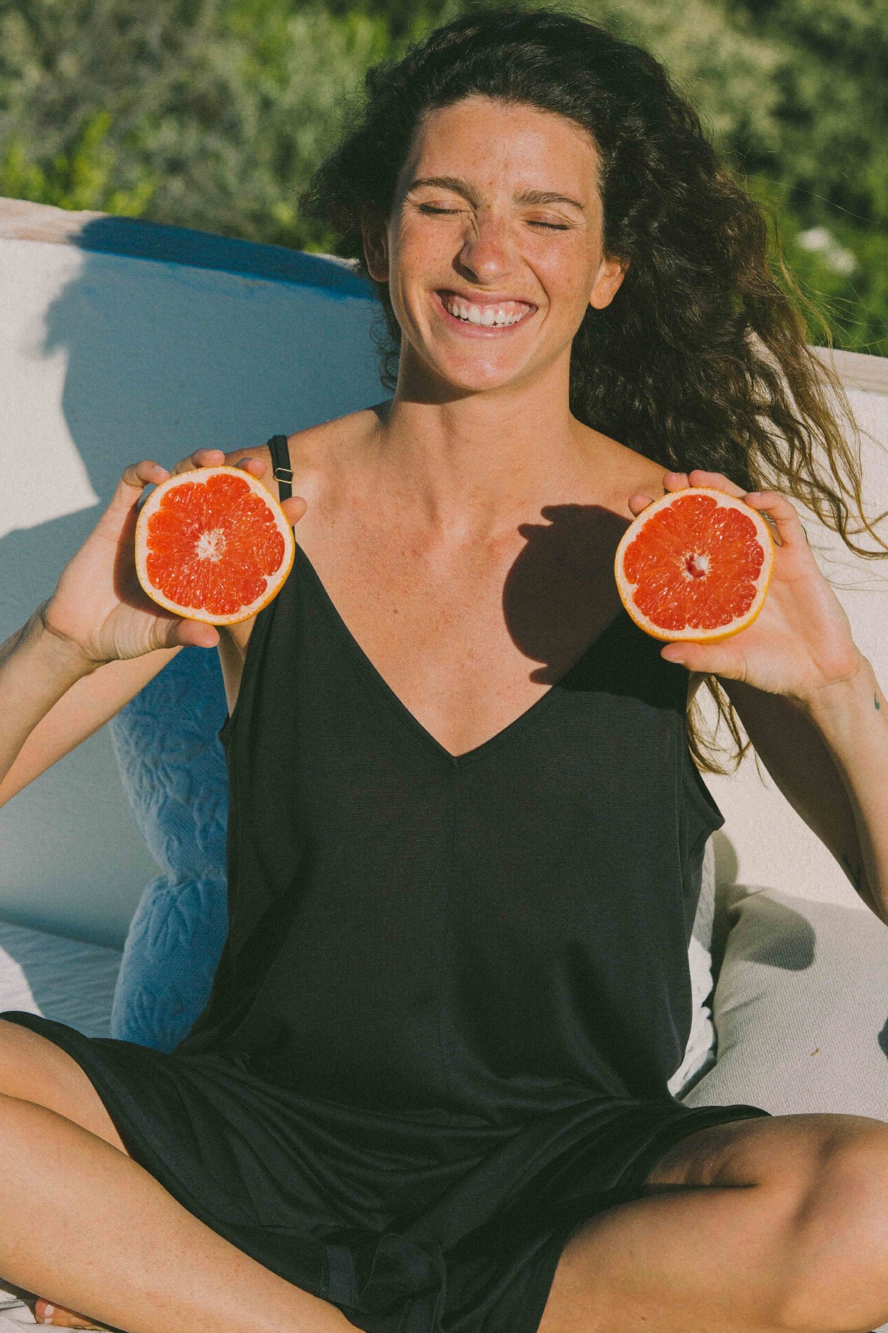 AWAN black slip dress in bright terrace sun