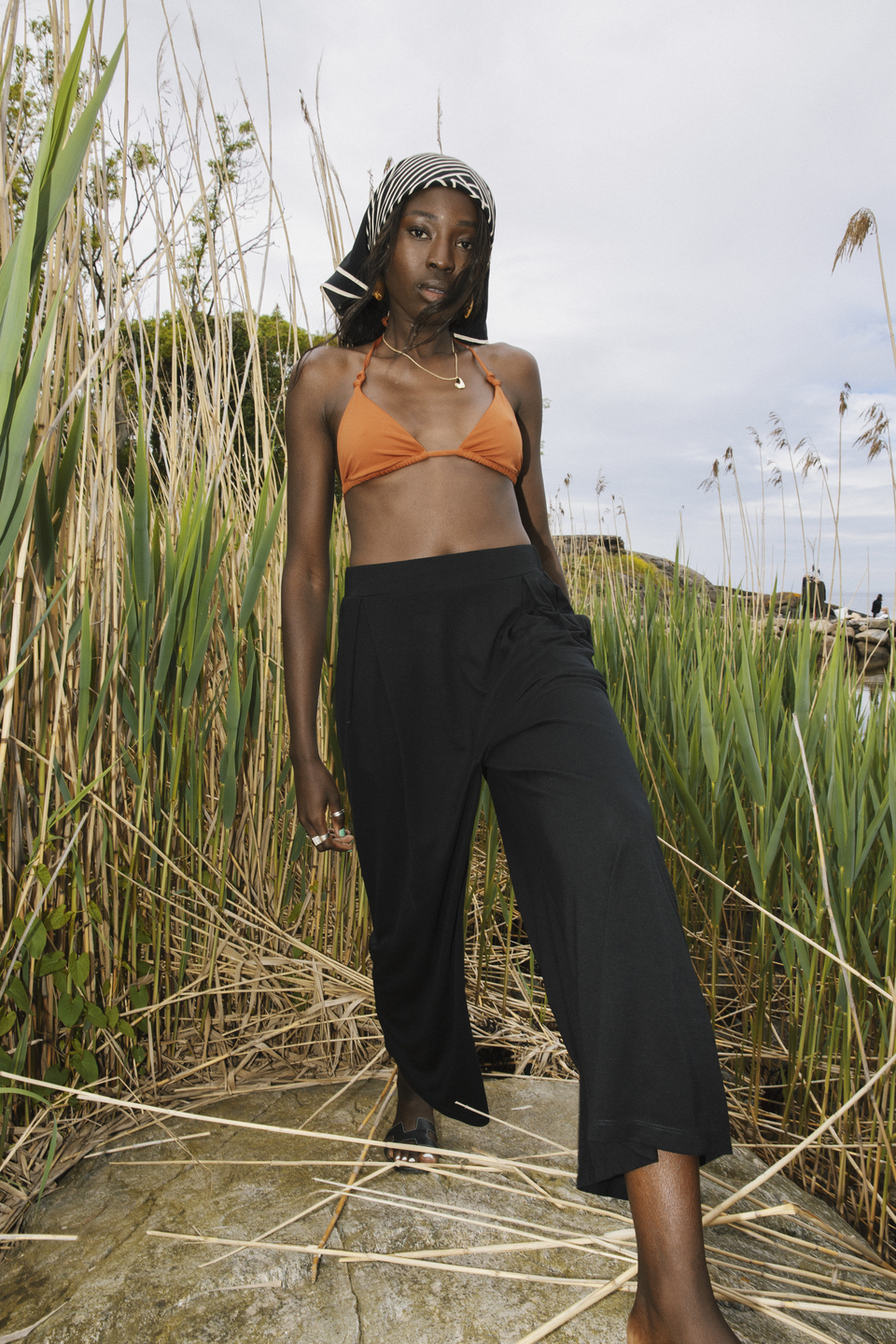 AWAN black flow trousers among coastal reeds