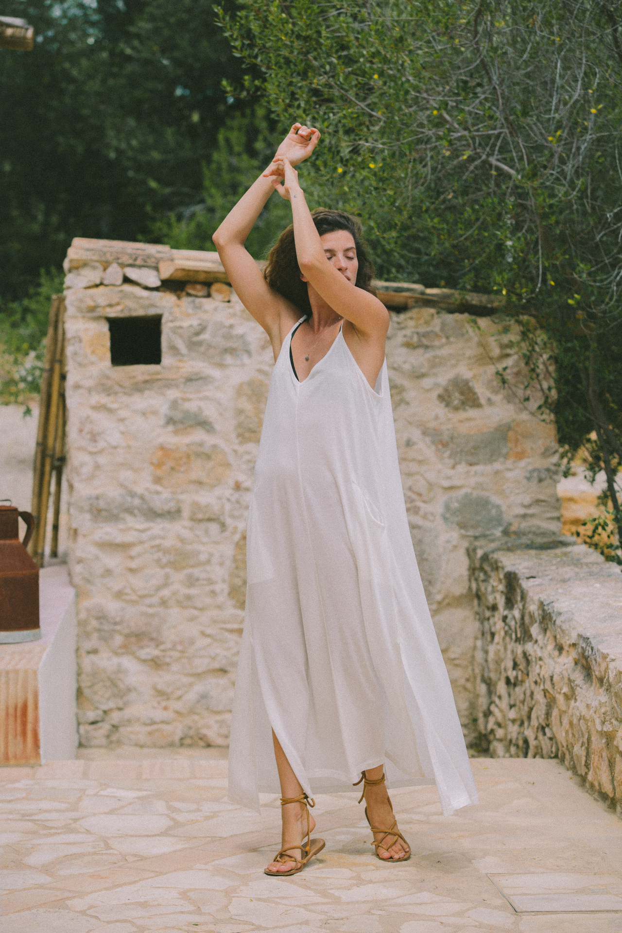 AWAN white flowing dress, stone courtyard